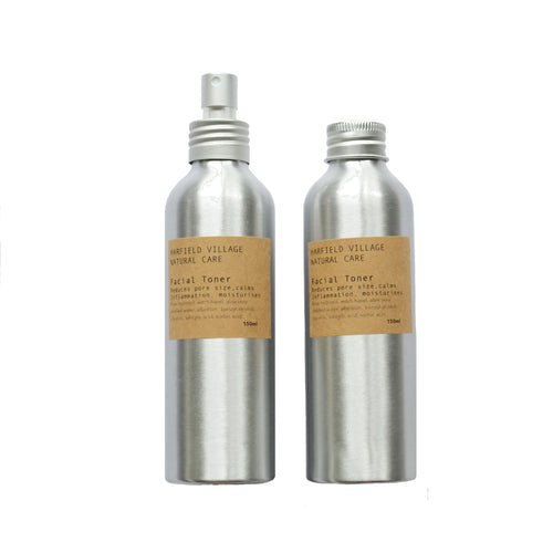 Two silver canisters with kraft labels, one with a metal spray nozzlw