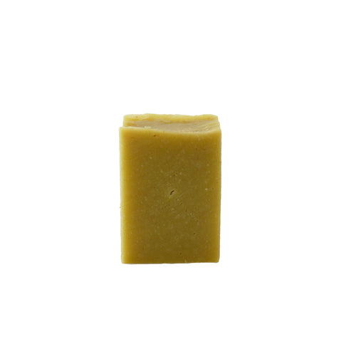 A single yellow rectangular bar of soap on a white background