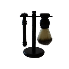 Load image into Gallery viewer, A black stand with a black razor and a black handled shaving brush hanging from it