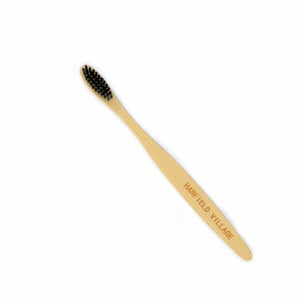 Natural colored bamboo toothbrush with black bristles